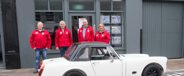 Simon Brien event sponsor, beside his 1960's MG Midget Atlantis GT, along with (left to right) Craig Hunt, Deputy Clerk of the Course, Wilson Carson, Clerk of the Course, and Sharon Carson, Secretary of the Meeting who are all delighted with the high quality entry list